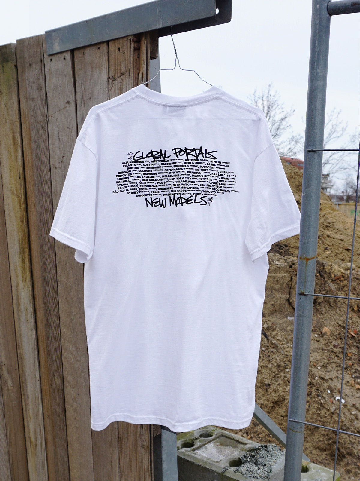 Back view: List of New Models' "Global Portals" screenprinted in black on back of 100% cotton white short-sleeve T.