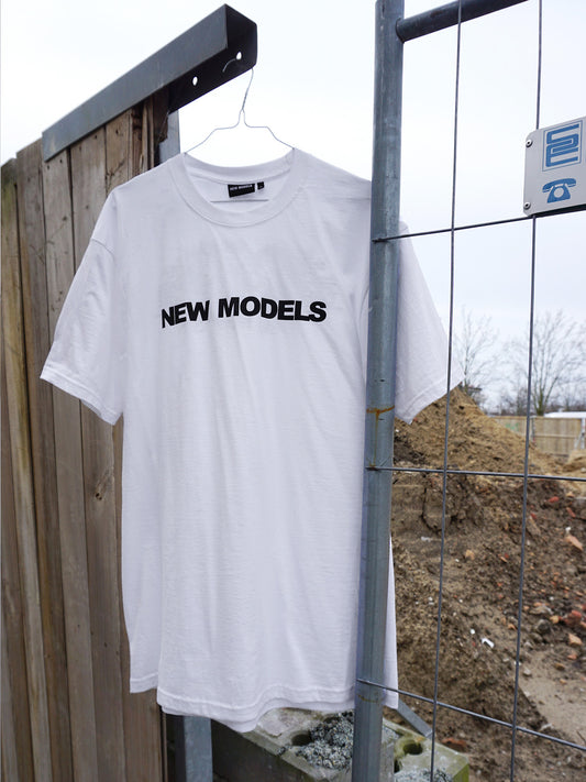 Front view: Black New Models logo screenprinted on 100% cotton white short-sleeve T. 